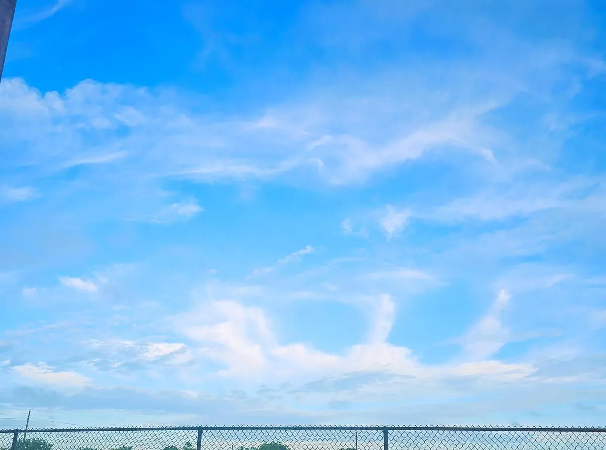 A vast blue sky with sweeping clouds — the heavens declare the glory of God